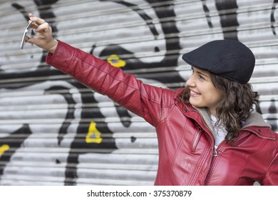 Pretty woman taking selfie outdoors with a gap