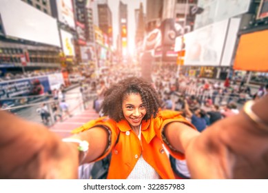 Pretty Woman Taking A Selfie At Times Square, New York - Afroamerican Girl Taking A Memorable Self Portrait With Smartphone While Traveling In A Crowded City