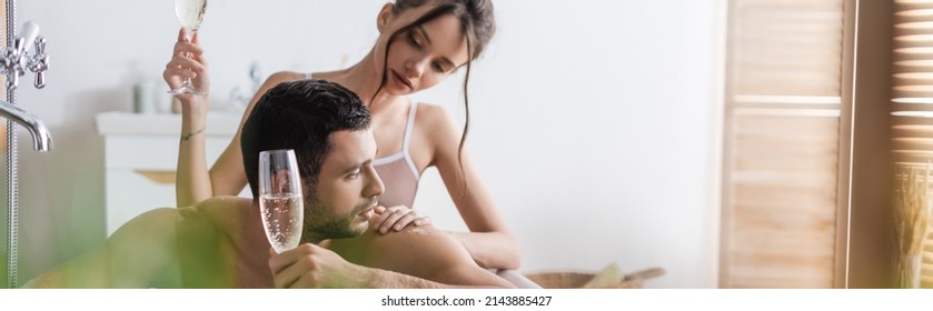 Pretty Woman Touching Muscular Man With Glass Of Champagne In Bathtub, Banner