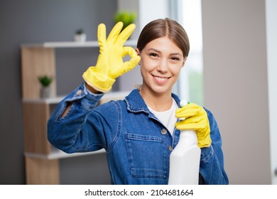 Pretty woman in uniform with supplies cleaning in office - Shutterstock ID 2104681664
