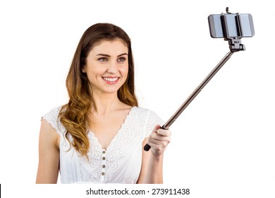 Pretty Woman Using A Selfie Stick On White Background