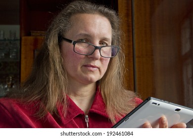 Pretty woman using tablet computer at home. 