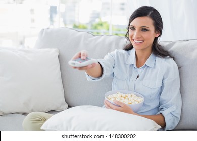 Pretty Woman Watching Tv Eating Popcorn In Her Living Room