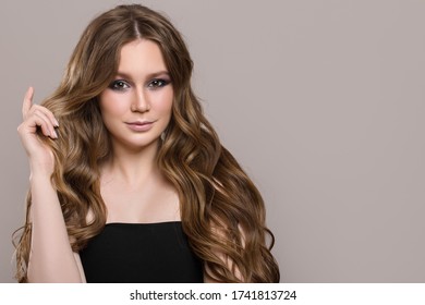 Pretty woman with wavy hair. Long curls - Shutterstock ID 1741813724