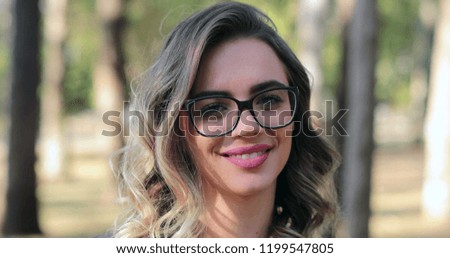 Pretty woman wearing glasses opening eyes and looking to camera smiling. Smart woman