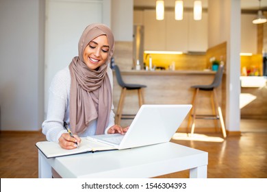 Pretty Woman Wearing Hijab In Front Of Laptop Search And Doing Office Work With Different Face Expression Isolated In Home Background - Office, Business, Finance And Work Station Concept