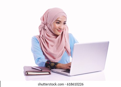 Pretty woman wearing hijab in front of laptop search and doing office work with different face expression isolated in white background - office, business, finance and work station concept - Powered by Shutterstock