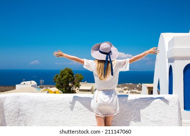 Pretty Woman In White Dress On Santorini In Creta