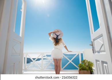 Pretty Woman In White Dress On Santorini In Creta