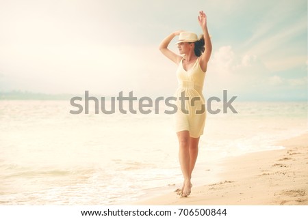 Pretty woman in white dress walking on beach on sunset.
Beach, sunset, nature evening. Love romance concept.