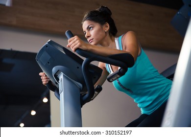 Pretty Woman Workout On Exercises Machine In Fitness Gym