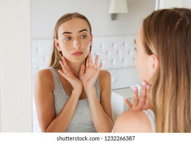 pretty woman,girl touching her neck while looking in the mirror, beauty and fashion concept,wrinkles