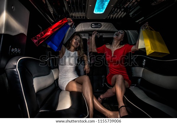 Pretty women having
party in a limousine car