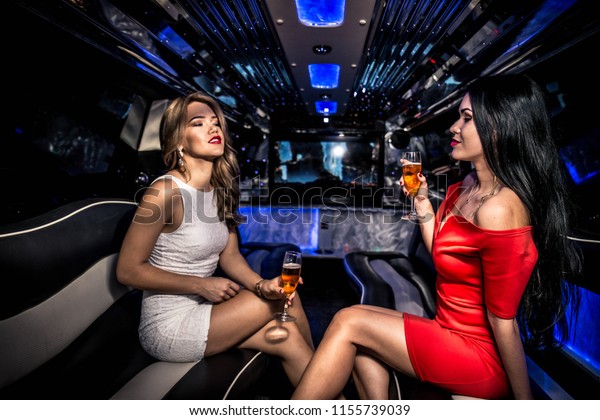 Pretty women having
party in a limousine car