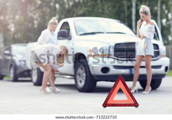 Pretty women\
having problem with car on the\
road