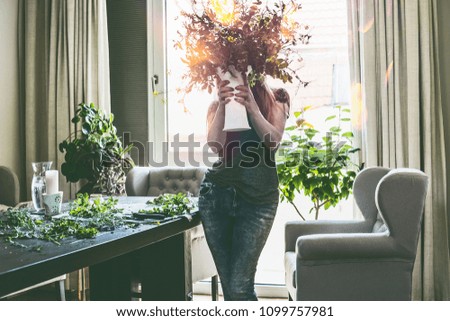 Similar – Woman makes bouquet in living room