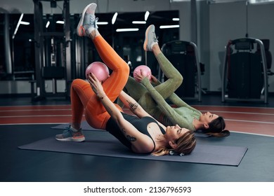 Pretty Women Working Out In A Gym. Adult Ladies With Beautiful Shaped Bodies.