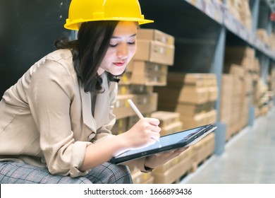 Pretty worker checking stock in the warehouse. Asian beautiful young woman worker of furniture store.Businesswoman using tablet in distribution stock. - Shutterstock ID 1666893436