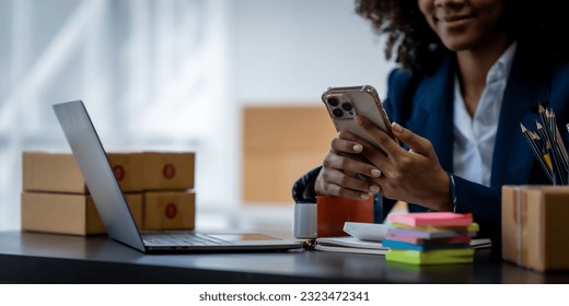 Pretty young african american woman startup freelancer business people is working at warehouse for online store. - Powered by Shutterstock