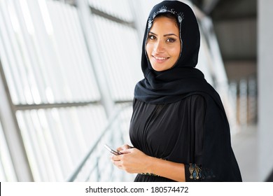 pretty young arabian woman holding smart phone