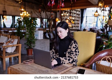 Pretty Young Asian Business Woman Using Laptop In Modern Cafe. 