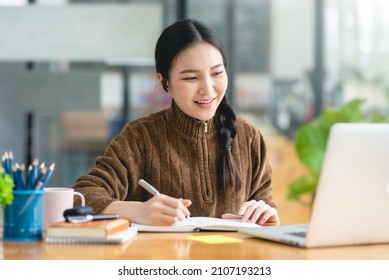 Pretty Young Asian Female Student Studying Online On Laptop Computer.