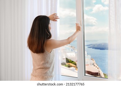 Pretty Young Asian Woman Opening Window At Resort