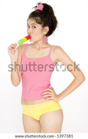 A pretty young asian woman sucking on an ice lolly