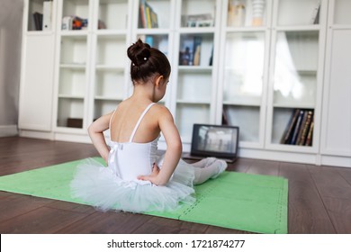 Pretty young ballerina practicing classic choreography during online class in ballet school, social distance during quarantine, self-isolation, online education concept