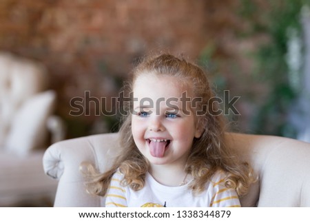 Pretty young beautiful girl kid teasing showing poke her tongue