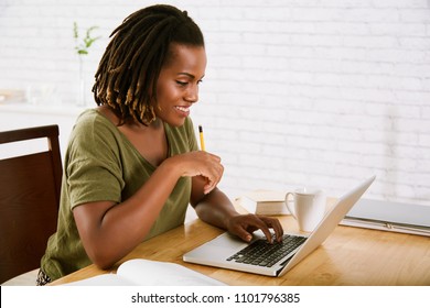 Pretty Young Black Woman Studying At Home