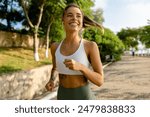 pretty young blond smiling woman doing sport exercises running jogging in morning park, skinny fit in sports wear outfit leggings and top, summer health motivation, strong body, hot