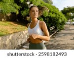 pretty young blond smiling woman doing sport exercises running jogging in morning park, skinny fit in sports wear outfit leggings and top, summer health motivation, strong body, hot