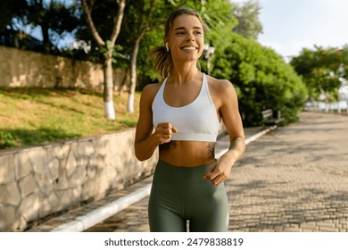 pretty young blond smiling woman doing sport exercises running jogging in morning park, skinny fit in sports wear outfit leggings and top, summer health motivation, strong body, hot - Powered by Shutterstock