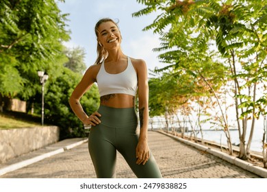 pretty young blond smiling woman doing sport exercises in morning park, skinny fit dressed in sports wear outfit leggings and top, summer health motivation, strong body, hot - Powered by Shutterstock