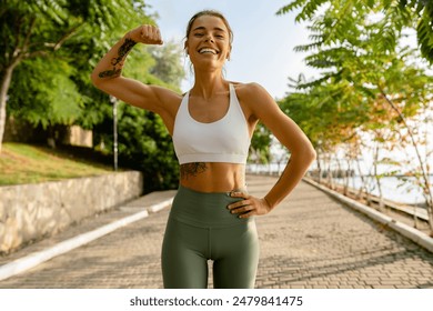 pretty young blond smiling woman doing sport exercises in morning park, skinny fit dressed in sports wear outfit leggings and top, summer health motivation, strong body muscles - Powered by Shutterstock