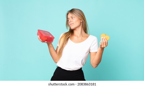 Pretty Young Blonde Woman Holding A Tupperware