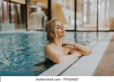 Pretty young blonde woman relaxing on the poolside - Powered by Shutterstock