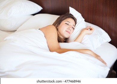 Pretty Young Brunette Getting Some Sleep On A Very Comfortable Bed In A Hotel