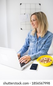 Pretty Young Business Woman Eating Nuts In Office