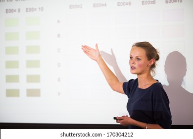 Pretty, young business woman giving a presentation in a conference/meeting setting (shallow DOF; color toned image) - Shutterstock ID 170304212