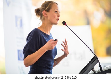 Pretty, young business woman giving a presentation in a conference/meeting setting (shallow DOF; color toned image) - Shutterstock ID 243396313