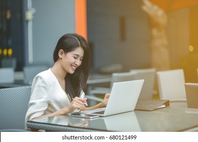 Pretty young business woman sitting on workplace, woman using laptop while sitting at her desk, businesswoman sitting in the office and working on laptop, woman using laptop, Selective focus. - Powered by Shutterstock