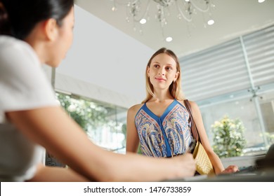 Pretty Young Caucasian Woman Standing At Front Desk In Spa Salon Or Hotel