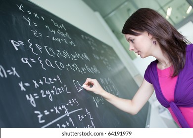 Pretty Young College Student Or Teacher Writing On The Chalkboard/blackboard During A Math Class (shallow DOF; Color Toned Image)