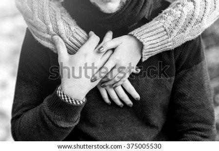 Joyful couple laughing together on a vintage sofa