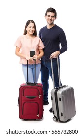 Pretty Young Couple Standing Together With Their Luggage And Travel Documents In A White Background