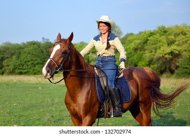 Pretty Young Cowgirl Riding Horse