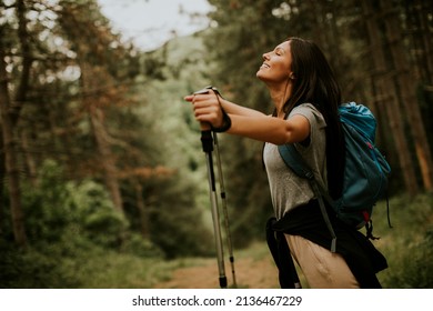 Pretty Young Female Backpacker Woman Enjoying Green Beautiful Forest Around Her