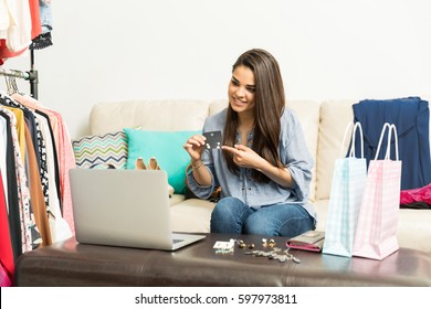 Pretty young female fashion blogger broadcasting a video with her laptop - Shutterstock ID 597973811